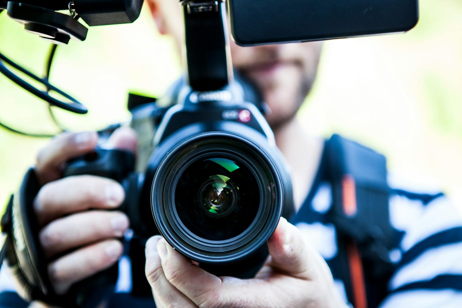 https://www.pexels.com/photo/person-holding-canon-dslr-camera-close-up-photo-320617/